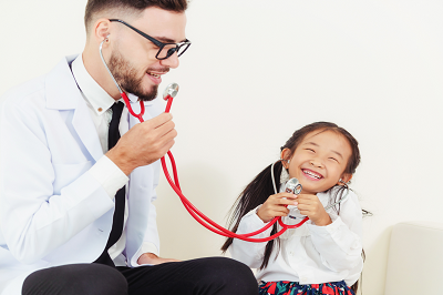 Doctor and young girl playing a stethoscope