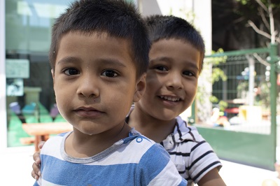 Twin boys wearing matching striped shirts