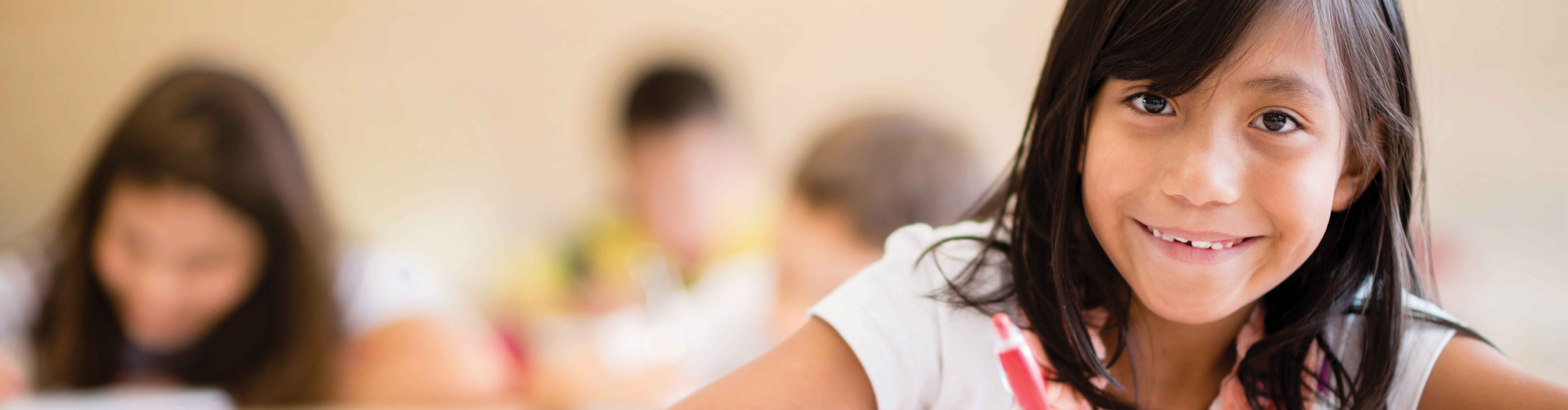 Smiling girl at desk