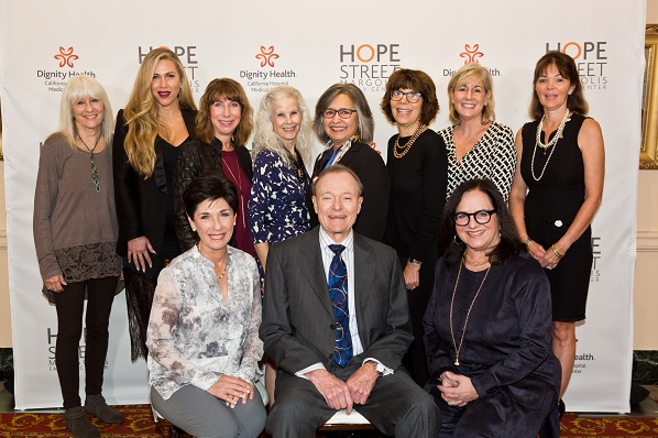 Eleven men and women stand around the Hope Street step & repeat to take a picture