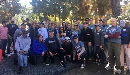 A large group of adults pose for a picture after volunteering at Hope Street