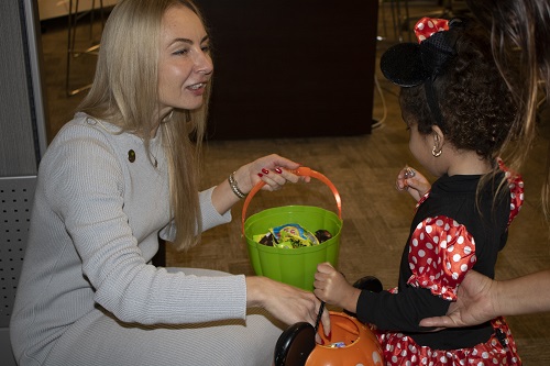 An AEG employee passes out candy to a little mini mouse